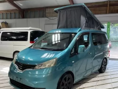 Green camper with roof up